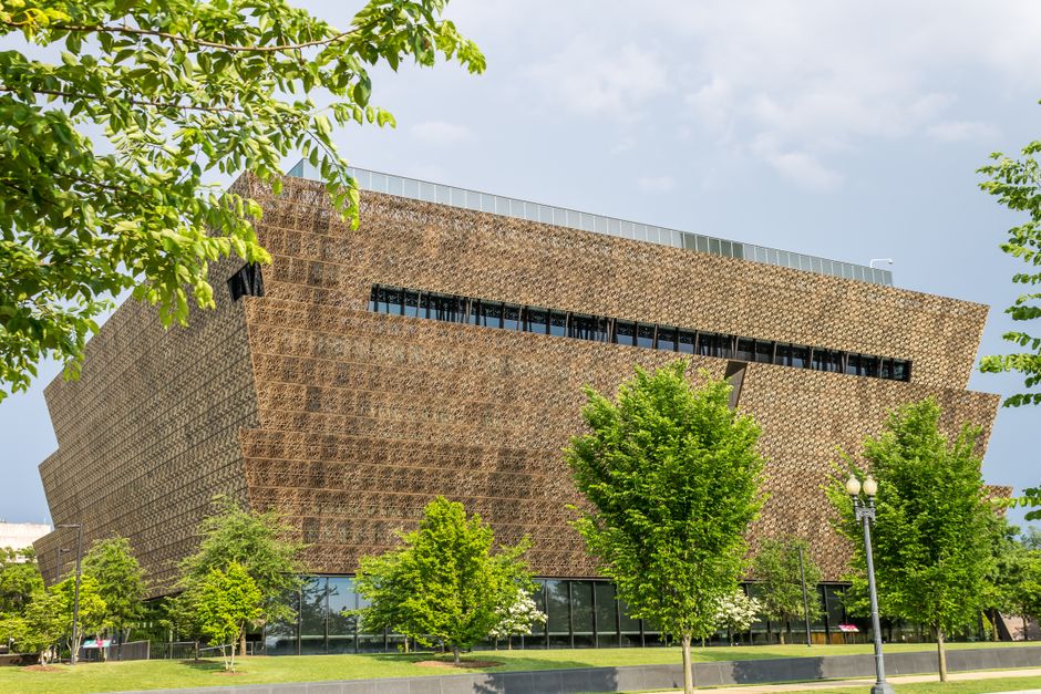 Striking museum architecture amidst vibrant urban greenery during a sunny day.