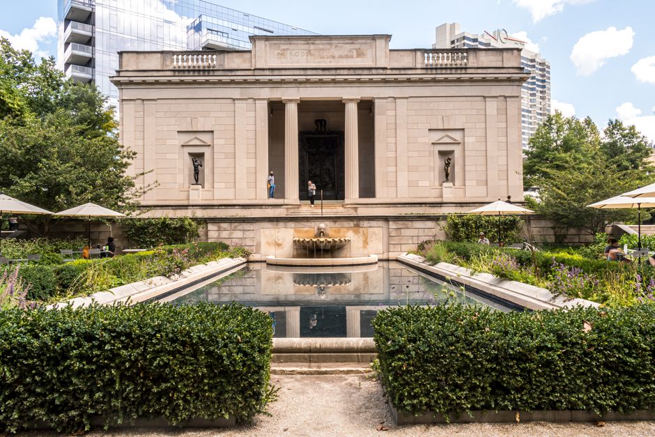 Capture of the grand Rodin Museum facade in Philadelphia with lush gardens and reflecting pool.